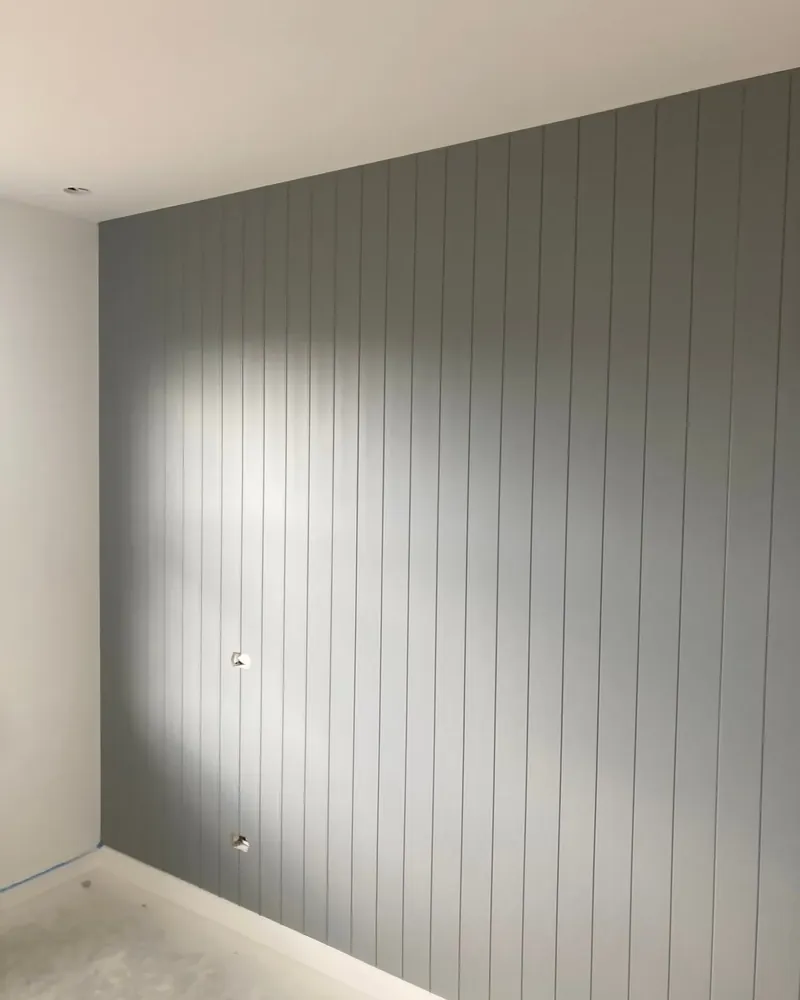 Grey panelled feature wall in a newly painted room