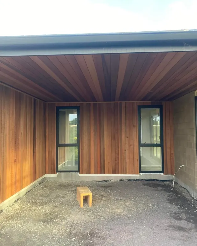 Carport with stained timber cladding on the walls and ceiling